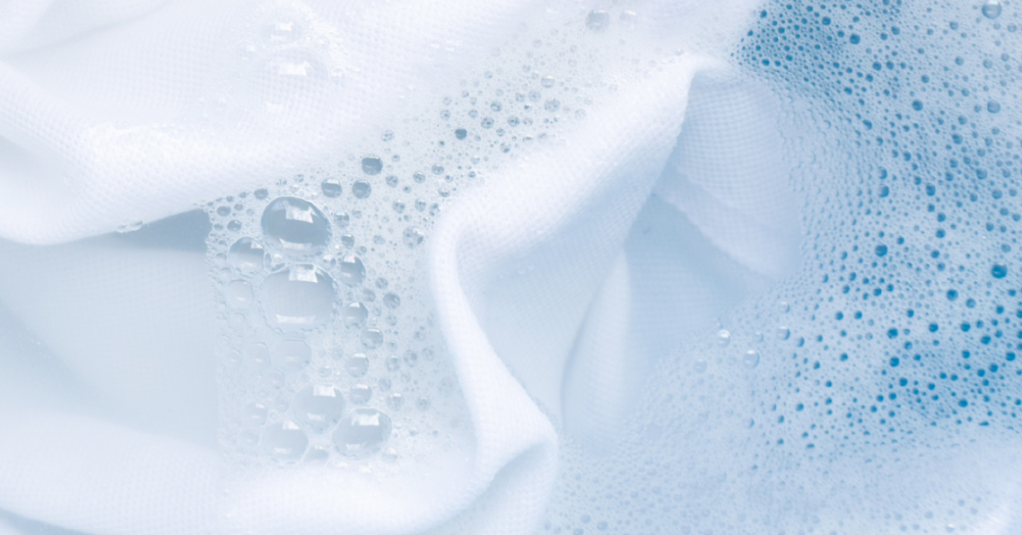 Picture of a white woven cloth in a washing bath
