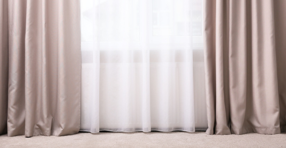 Picture of a window with transparent and opaque curtains after blackout coating